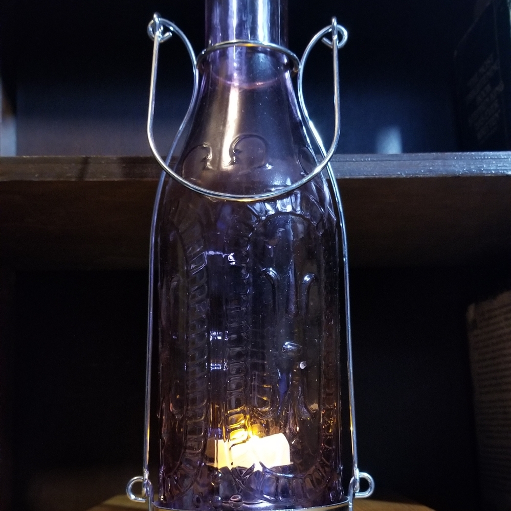 Purple glass bottle candle holder